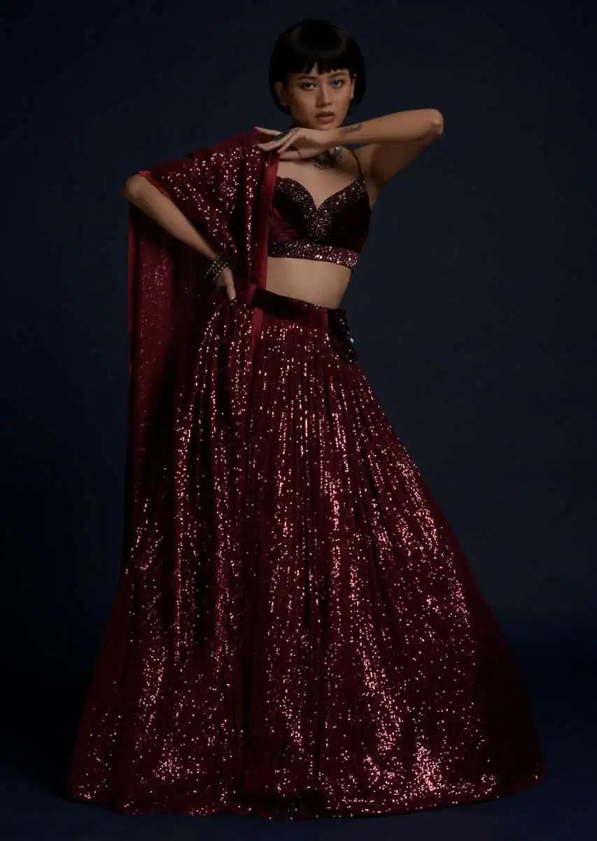Burgundy Lehenga Skirt Embellished In Sequins Featuring A Velvet Crop Top Matching Belt Bag