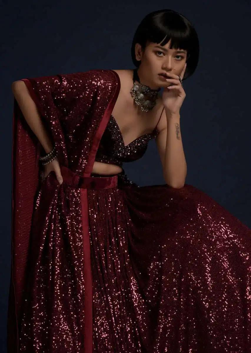 Burgundy Lehenga Skirt Embellished In Sequins Featuring A Velvet Crop Top Matching Belt Bag
