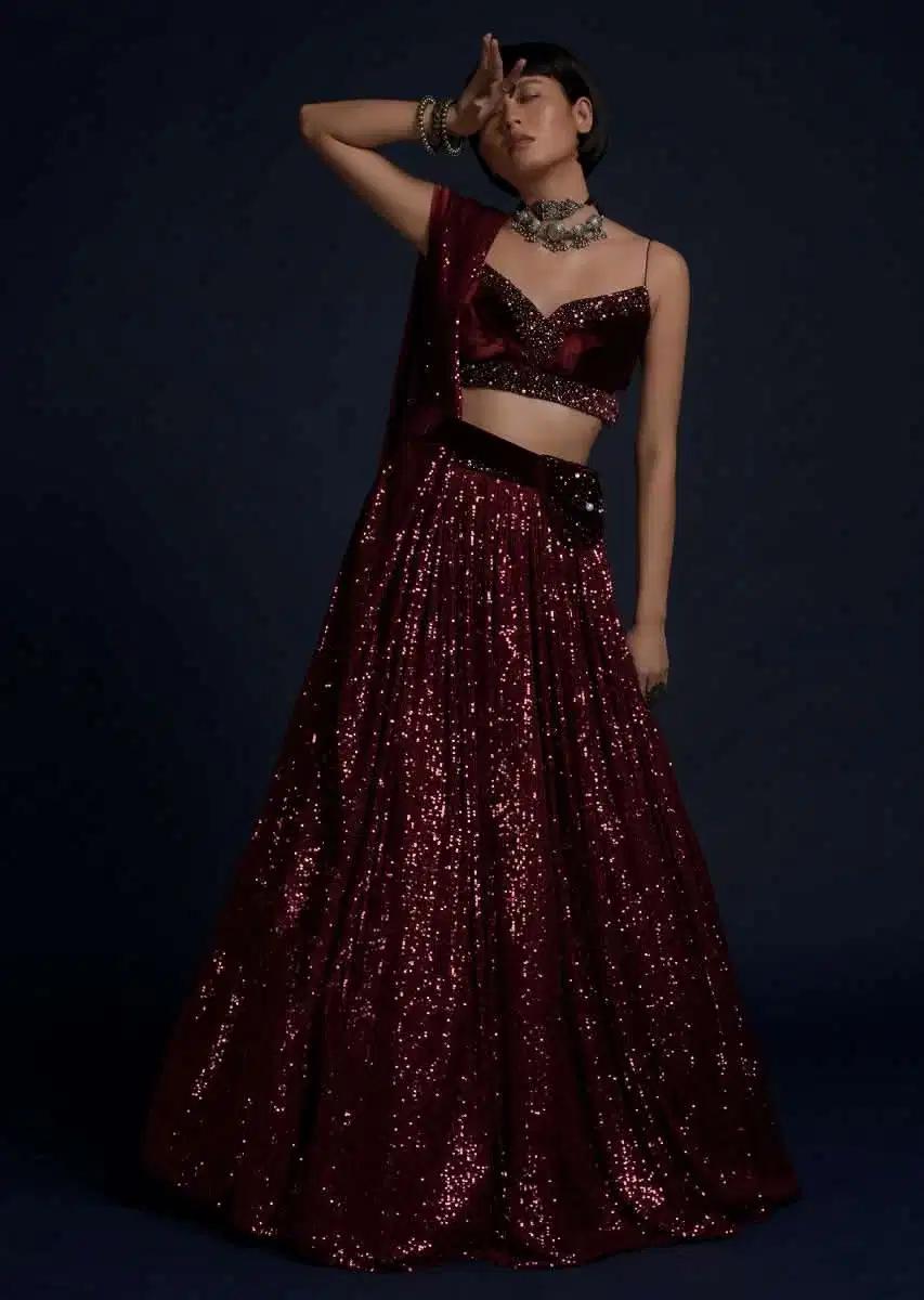 Burgundy Lehenga Skirt Embellished In Sequins Featuring A Velvet Crop Top Matching Belt Bag