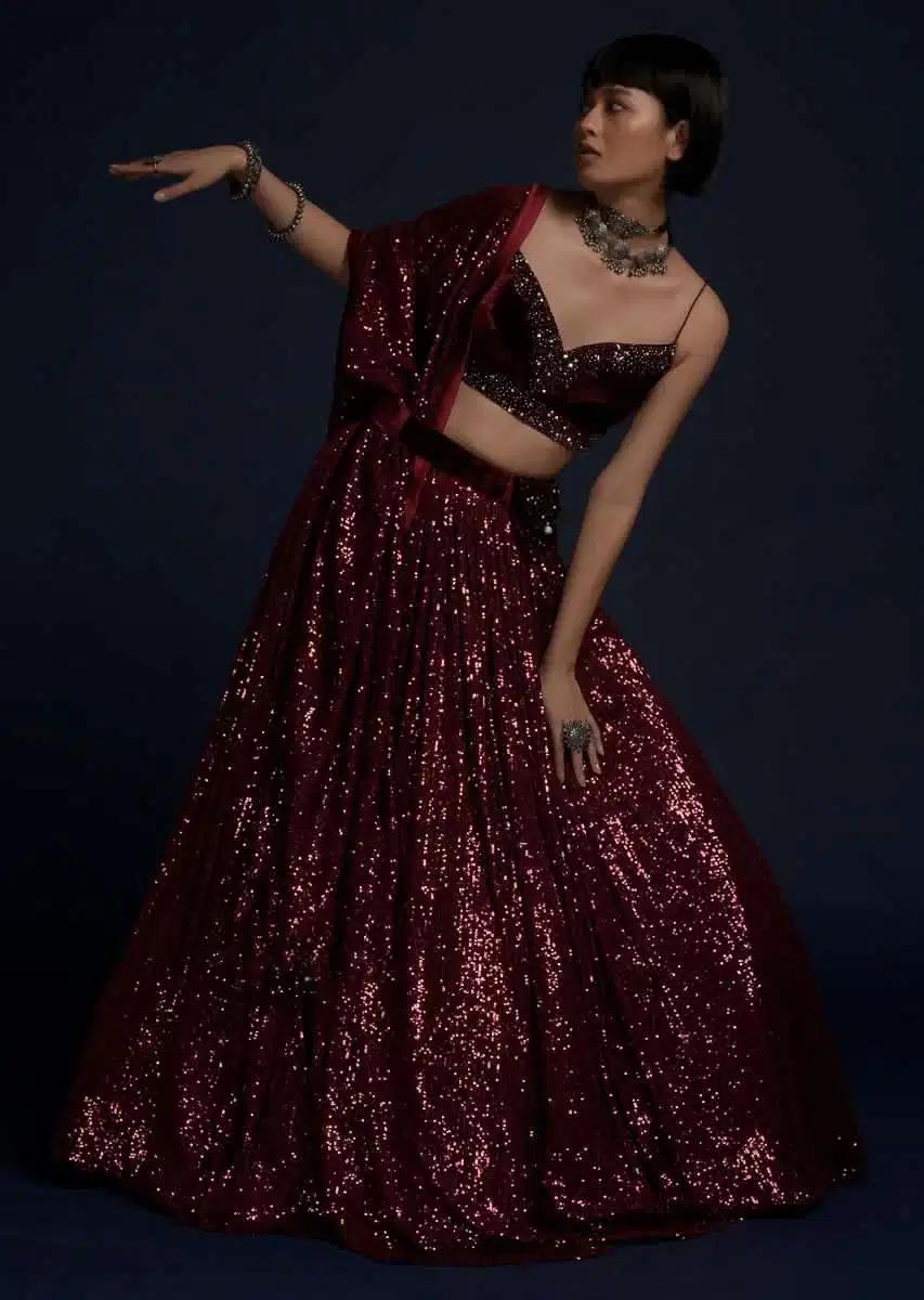 Burgundy Lehenga Skirt Embellished In Sequins Featuring A Velvet Crop Top Matching Belt Bag