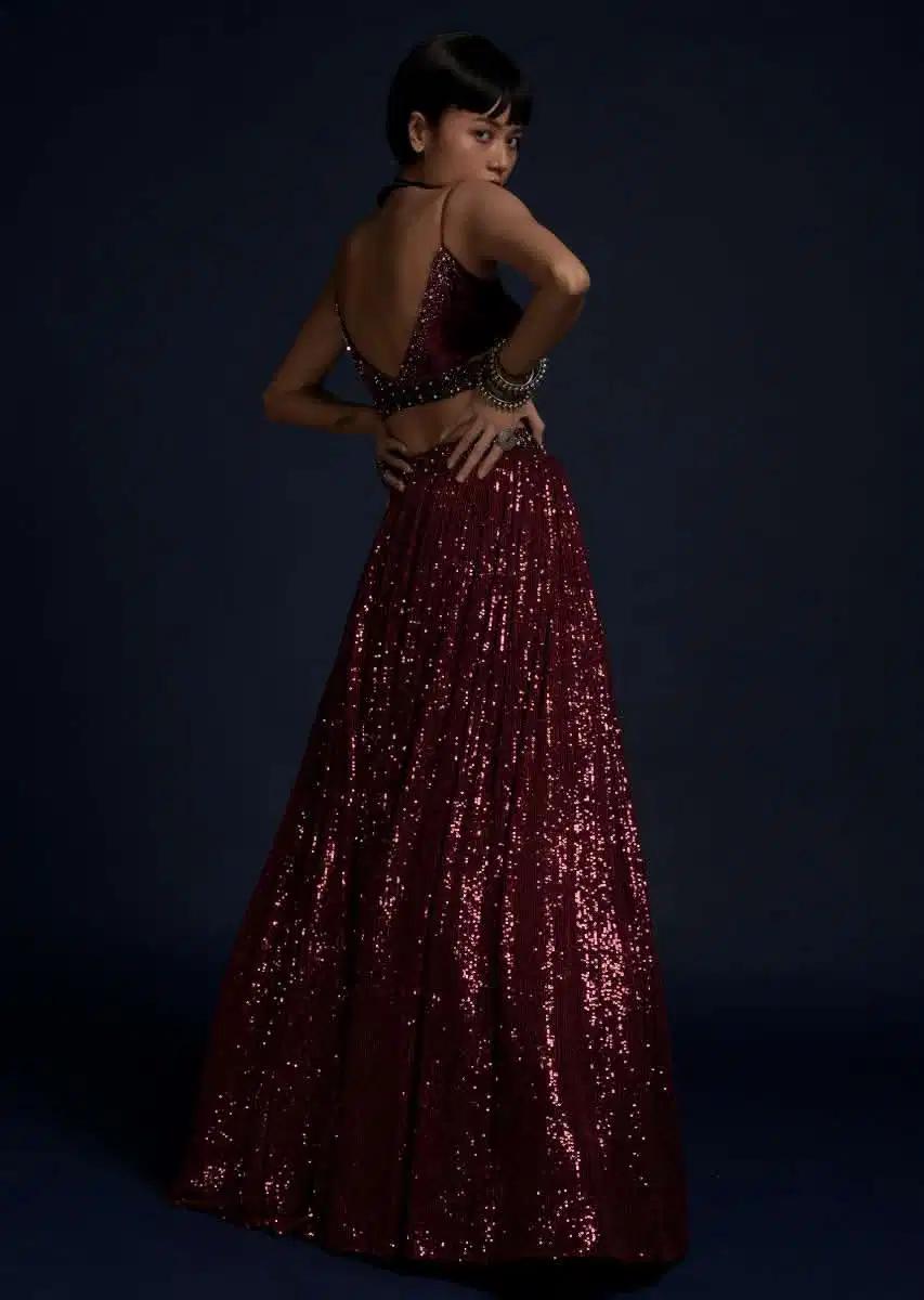Burgundy Lehenga Skirt Embellished In Sequins Featuring A Velvet Crop Top Matching Belt Bag